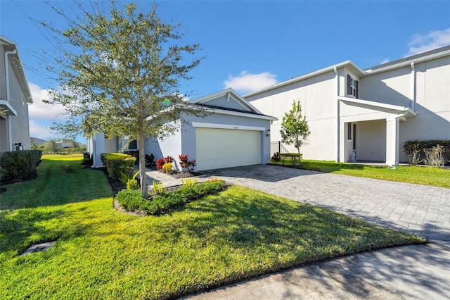 view of front of home with a front yard and a garage