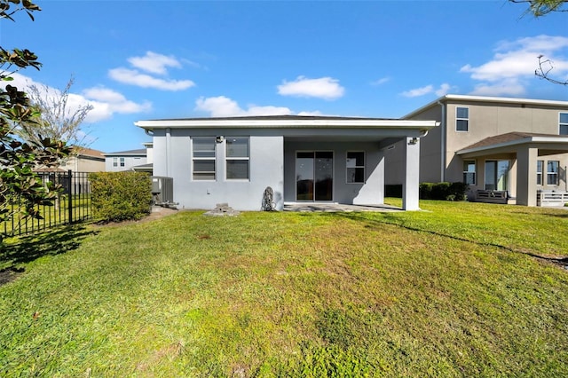 rear view of house with a lawn