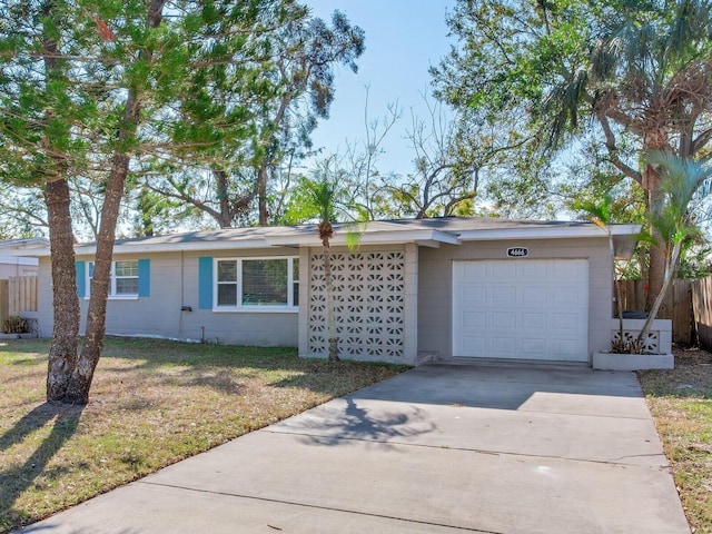 ranch-style home featuring a front yard and a garage