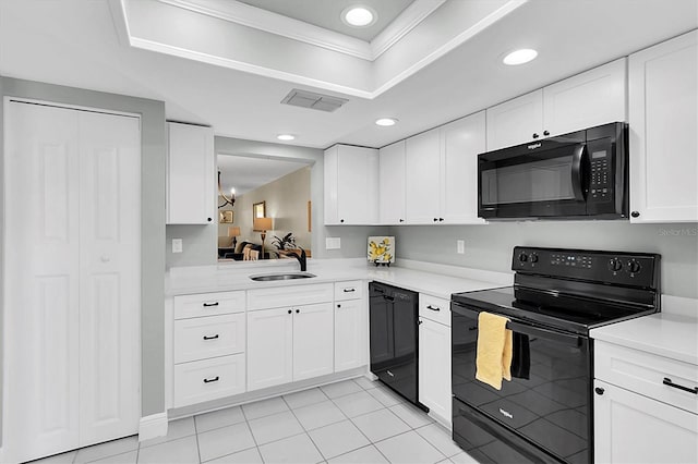 kitchen featuring sink, white cabinets, black appliances, and ornamental molding