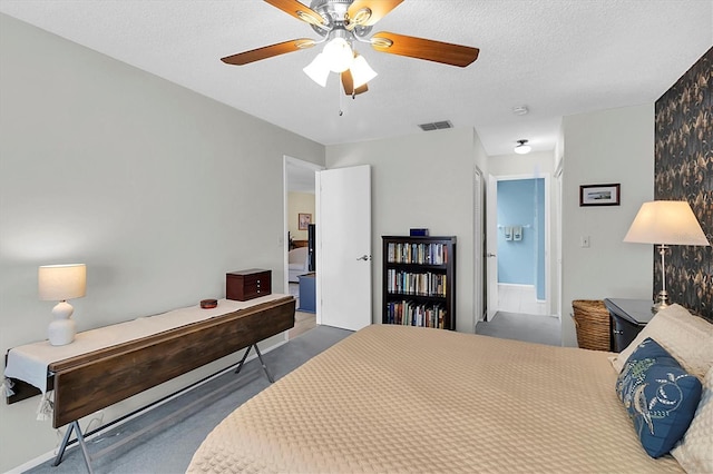 carpeted bedroom featuring a textured ceiling and ceiling fan