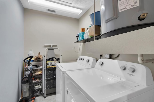 washroom with separate washer and dryer and a textured ceiling