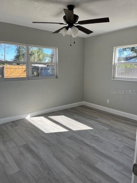 unfurnished room featuring ceiling fan and hardwood / wood-style flooring