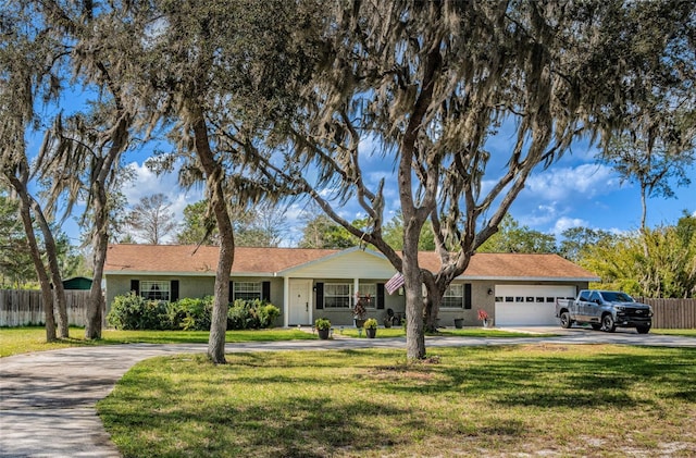 ranch-style house featuring a front yard, a porch, and a garage