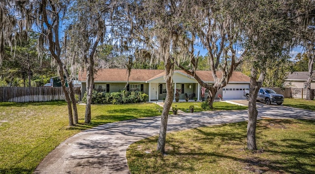 ranch-style house featuring a garage and a front lawn