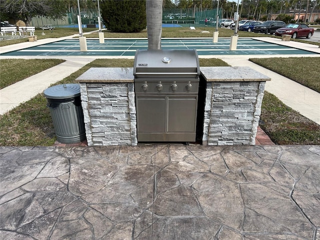 view of patio with an outdoor kitchen and a grill