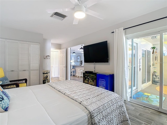 bedroom featuring a closet, access to exterior, ceiling fan, and light hardwood / wood-style flooring