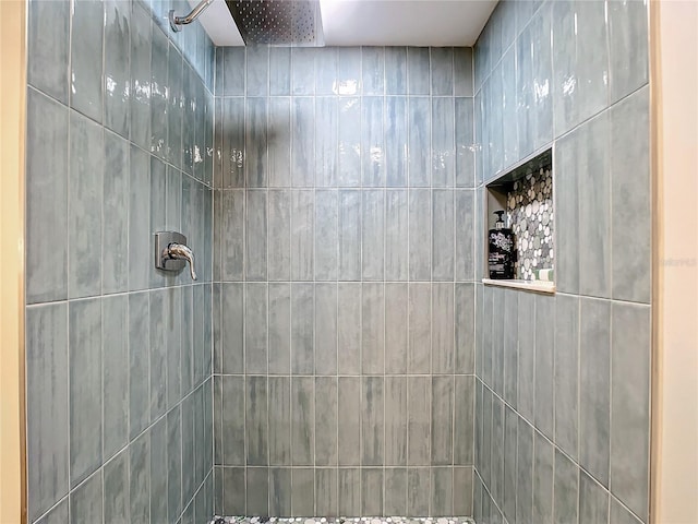 bathroom with tiled shower