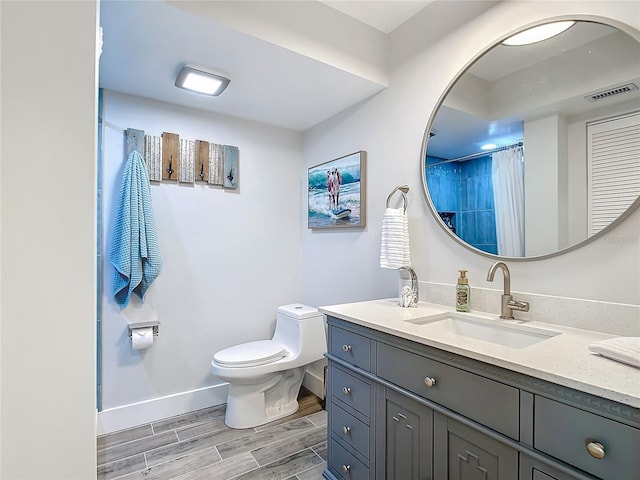 bathroom with vanity, toilet, and a shower with shower curtain