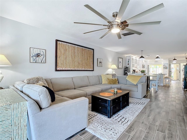 living room with hardwood / wood-style flooring and ceiling fan