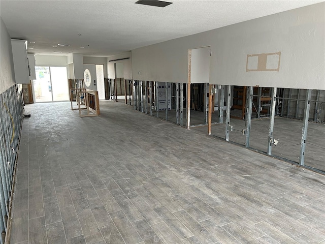 interior space with hardwood / wood-style floors and a textured ceiling