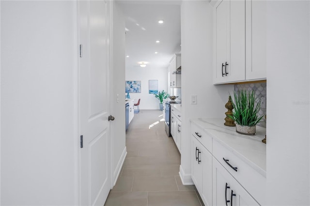 hall featuring light tile patterned floors