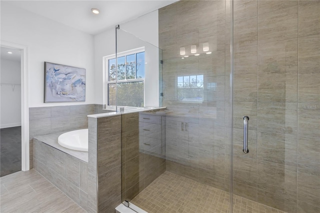 bathroom featuring shower with separate bathtub and tile patterned floors