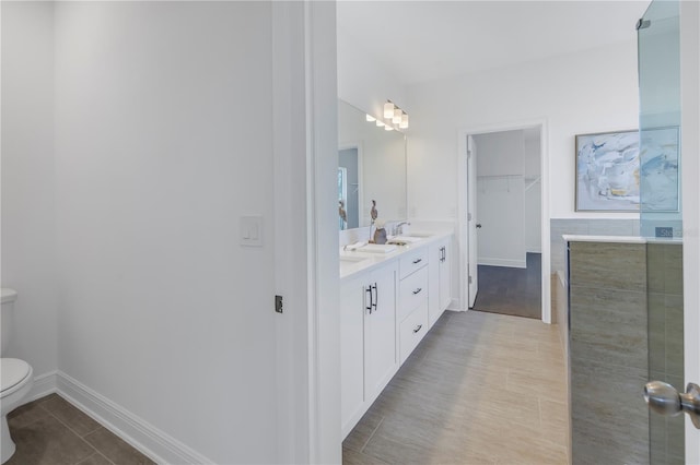 bathroom featuring tile patterned floors, vanity, and toilet