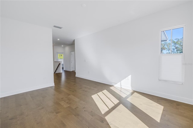 unfurnished room with dark hardwood / wood-style floors