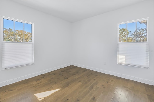 spare room with dark hardwood / wood-style floors