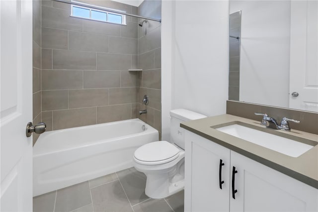 full bathroom featuring tile patterned floors, tiled shower / bath combo, toilet, and vanity