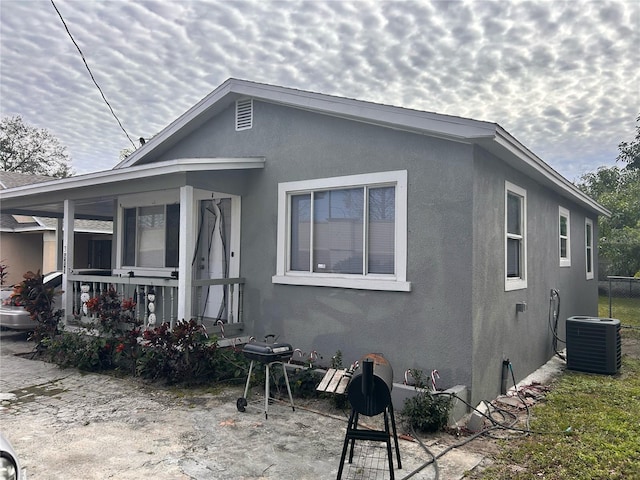 exterior space featuring covered porch and cooling unit