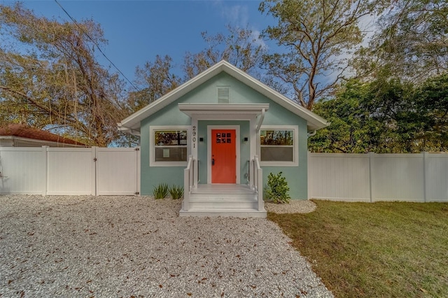 bungalow-style home with a front yard