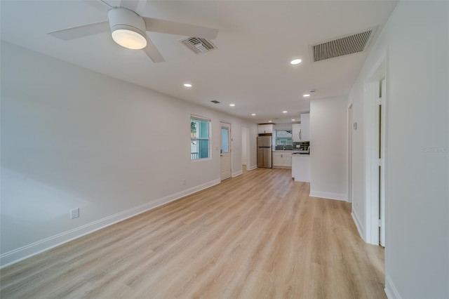 unfurnished living room with ceiling fan and light hardwood / wood-style flooring