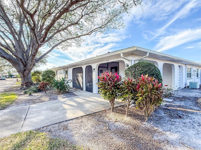 ranch-style home with central air condition unit