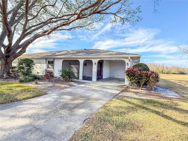 ranch-style home featuring a carport and a front yard