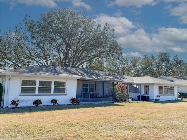 ranch-style house featuring central AC, a sunroom, and a front yard