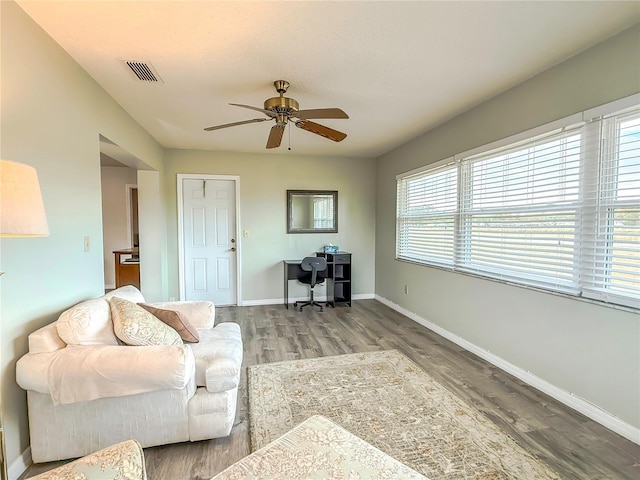 living room featuring hardwood / wood-style floors and ceiling fan