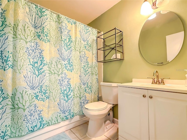 bathroom featuring vanity, tile patterned floors, and toilet