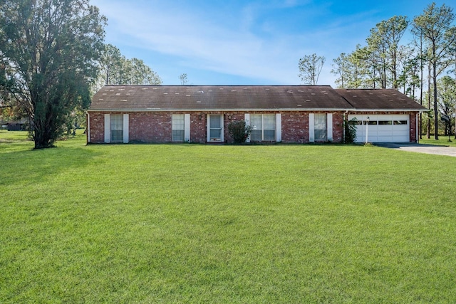 single story home featuring a garage and a front lawn