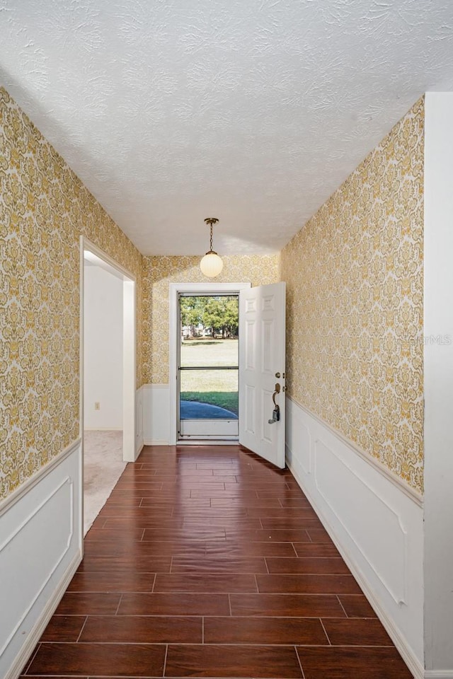 doorway with a textured ceiling