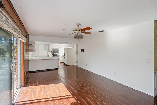 unfurnished living room with ceiling fan