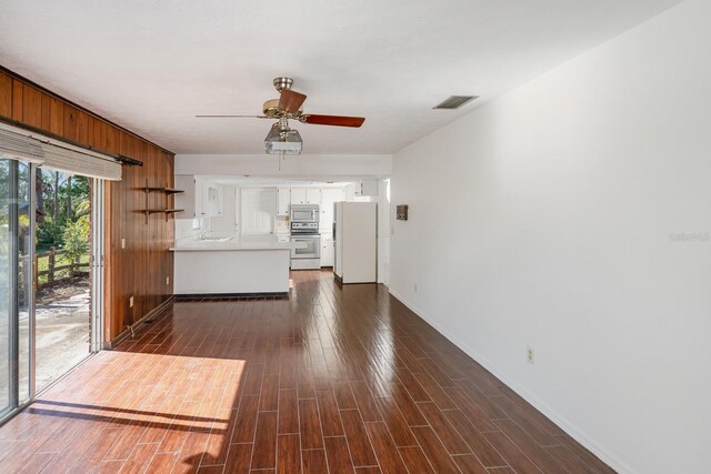 unfurnished living room with ceiling fan