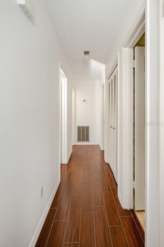 hallway featuring a textured ceiling