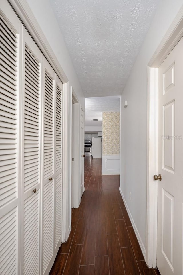 hall with a textured ceiling