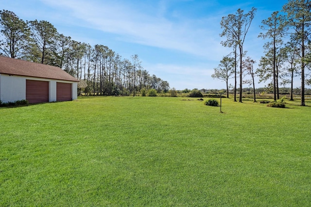 view of yard with an outbuilding and a garage