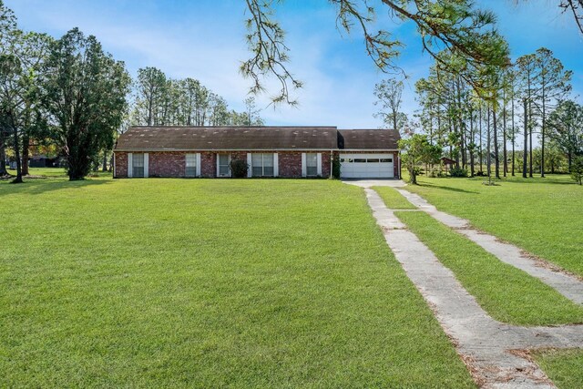 ranch-style house with a garage and a front lawn