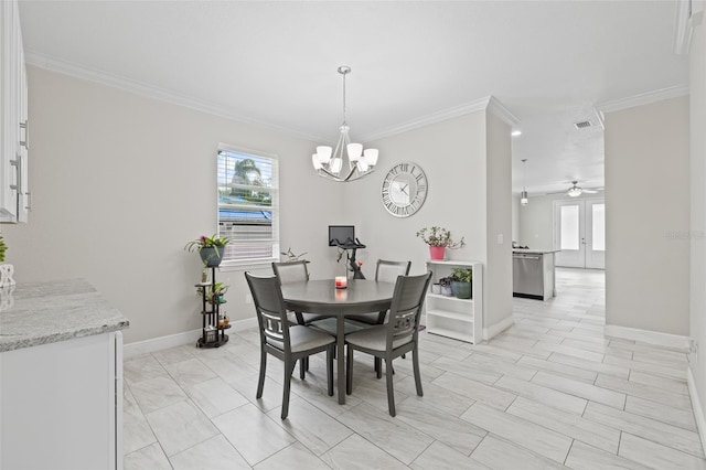 dining area featuring a wealth of natural light, crown molding, french doors, and ceiling fan with notable chandelier