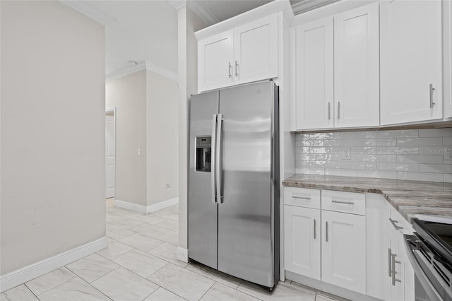 kitchen featuring range, white cabinets, decorative backsplash, ornamental molding, and stainless steel fridge with ice dispenser