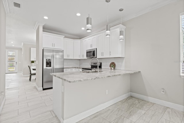 kitchen with white cabinets, decorative light fixtures, stainless steel appliances, and kitchen peninsula