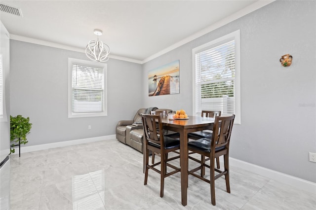 dining area with crown molding and an inviting chandelier