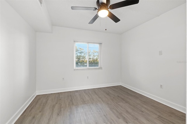 empty room featuring hardwood / wood-style flooring and ceiling fan