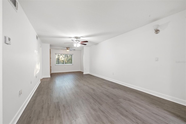 unfurnished room featuring ceiling fan and dark hardwood / wood-style flooring