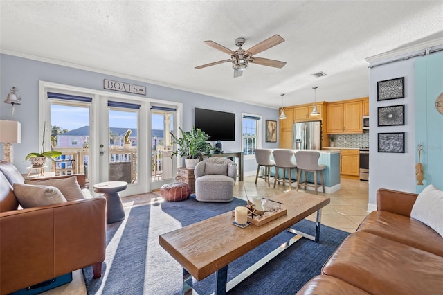 living room with french doors, light tile patterned floors, a textured ceiling, and ceiling fan