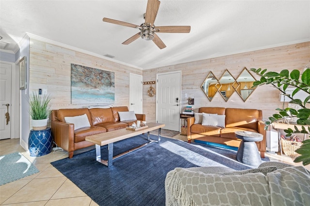 tiled living room featuring ornamental molding, ceiling fan, and wooden walls