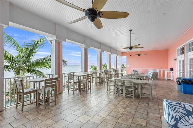 view of patio / terrace featuring ceiling fan and a water view