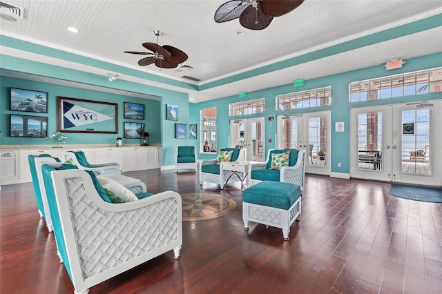 sitting room featuring french doors, dark wood-type flooring, and ornamental molding