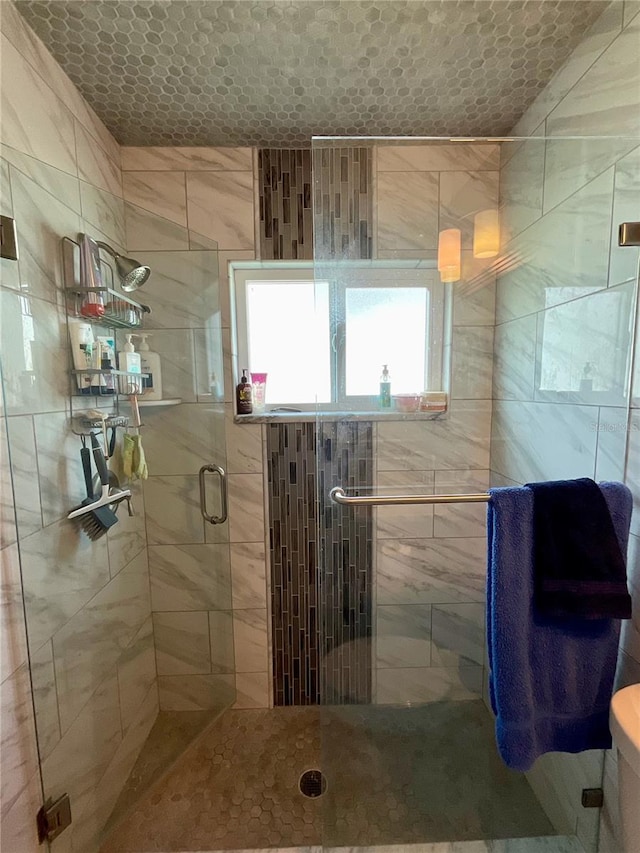 bathroom with an enclosed shower and toilet