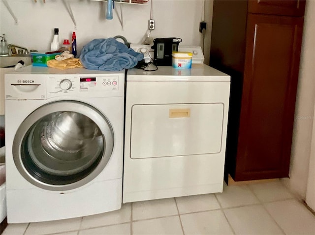 laundry area featuring independent washer and dryer and light tile patterned floors