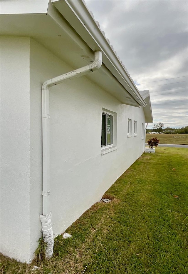 view of side of home featuring a yard